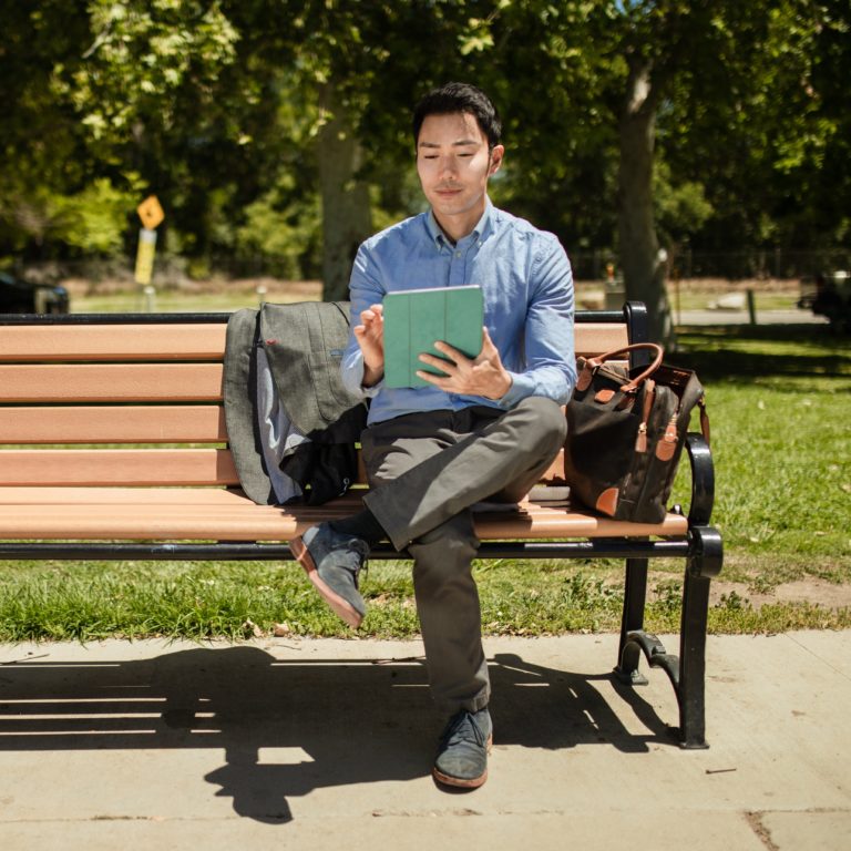 Man sitting on bench with Tablet